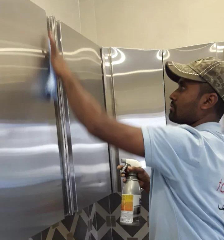 Person cleaning kitchen